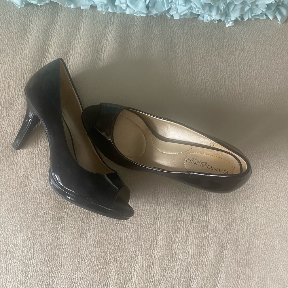 Black patent leather pumps with open to and 1/2 inch platform.